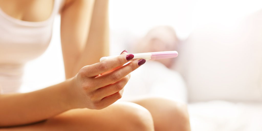 Woman holds pregnancy test 