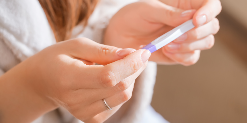 Female hands holding pregnancy test 