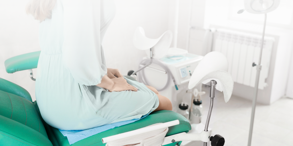 Woman sets in medical exam room